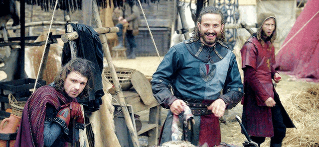 a group of medieval men are standing next to each other in a field
