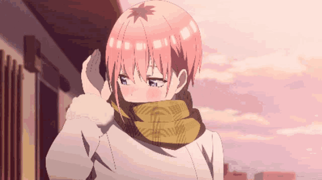 a girl with pink hair is wearing a scarf around her neck .