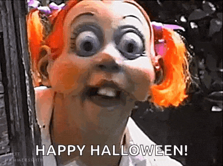 a doll with orange hair and big eyes is making a funny face and saying happy halloween .