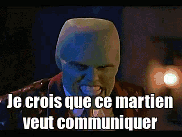 a man with a mask on his face and the words le crois que ce martien veut communiquer on the bottom