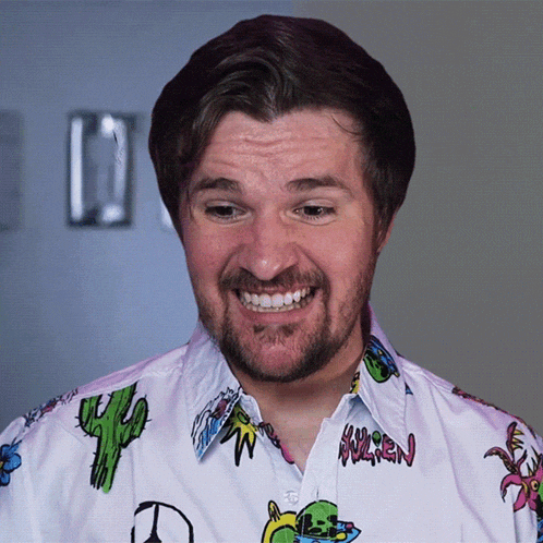 a man with a beard wears a shirt with a cactus on it and the word warren on the front