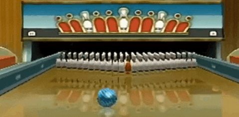 a bowling alley with a row of pins and a blue ball