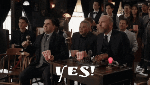a group of men sitting at a table with the word yes on the table