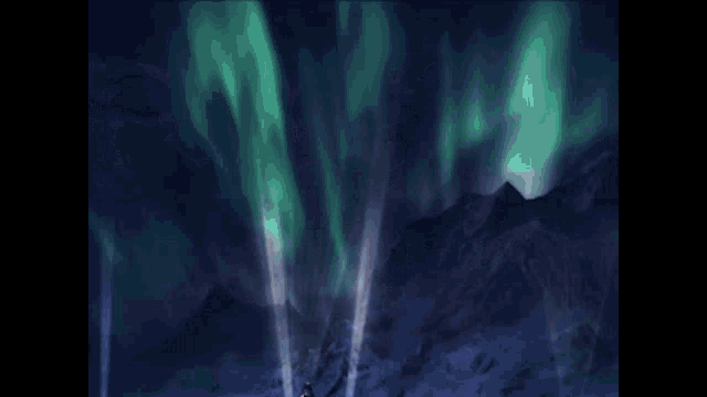 a person is riding a green and white snowmobile in the snow