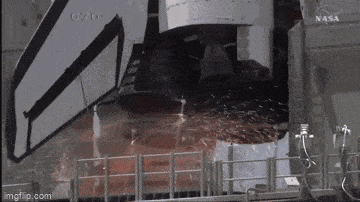 a close up of a space shuttle engine with a nasa logo in the background .