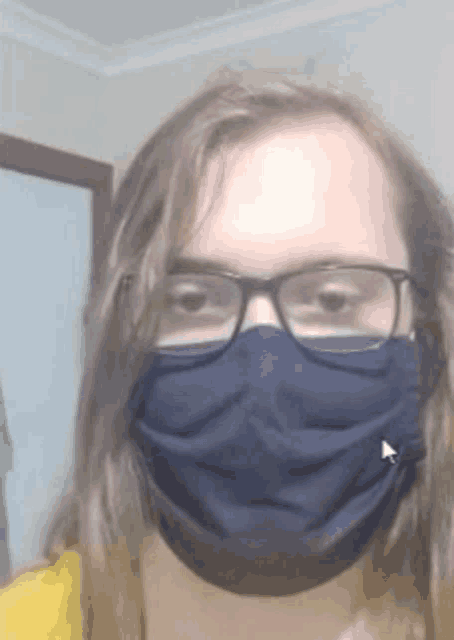 a young woman wearing glasses and a blue face mask .