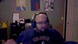 a man wearing a braves shirt and headphones