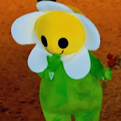 a stuffed flower with a yellow face and white petals
