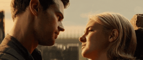 a man and a woman are looking at each other