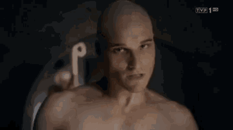 a man without a shirt is being shown on tvp 1