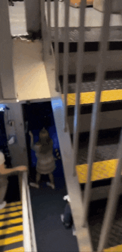 a person standing on a set of stairs with a yellow stripe on the bottom