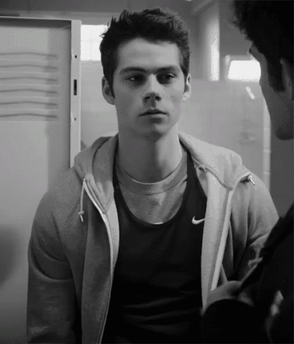 a black and white photo of a man wearing a nike jacket
