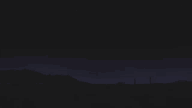 a lighthouse in the middle of a dark field at night