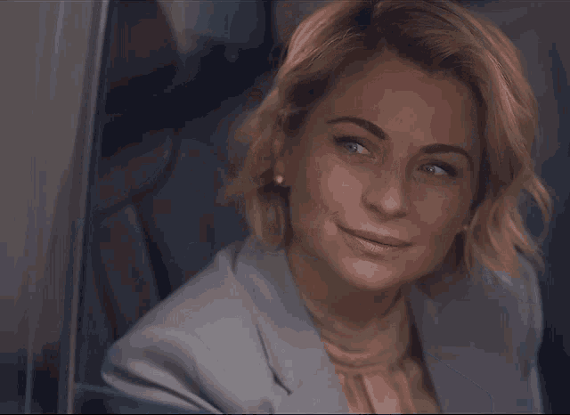 a close up of a woman 's face with a smile on her face