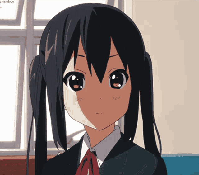 a close up of a girl 's face with the word shinobuo on the bottom