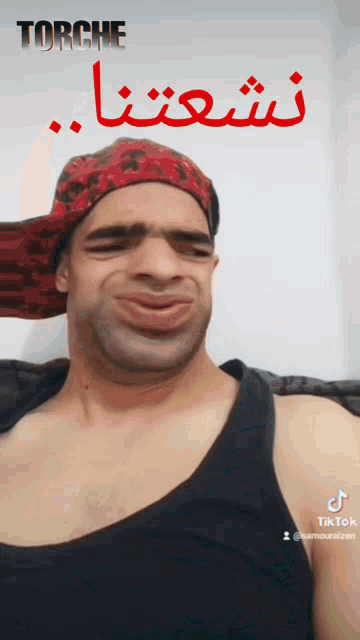 a man wearing a red bandana and a black tank top is making a funny face with the word torche written above him