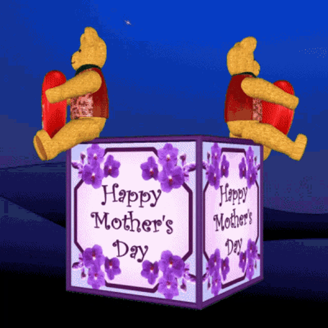 two teddy bears sit on top of a happy mother 's day box