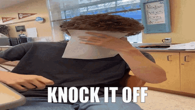 a person covering their face with a piece of paper that says knock it off on the bottom