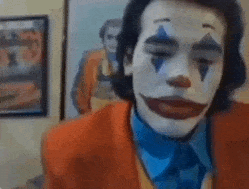 a man is wearing a clown costume and a blue tie .