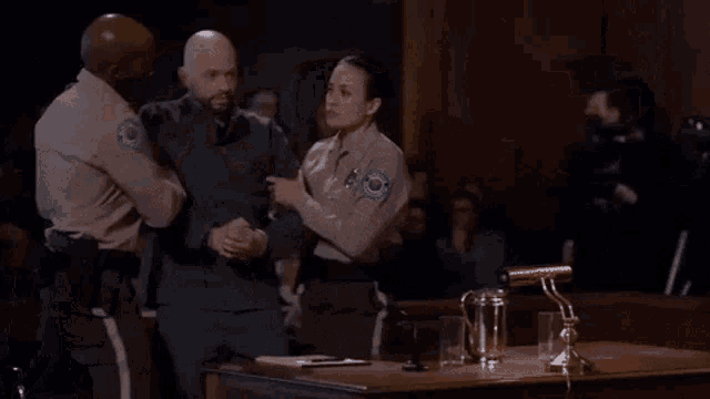 a woman in a striped shirt is dancing with a man in a suit in a room .