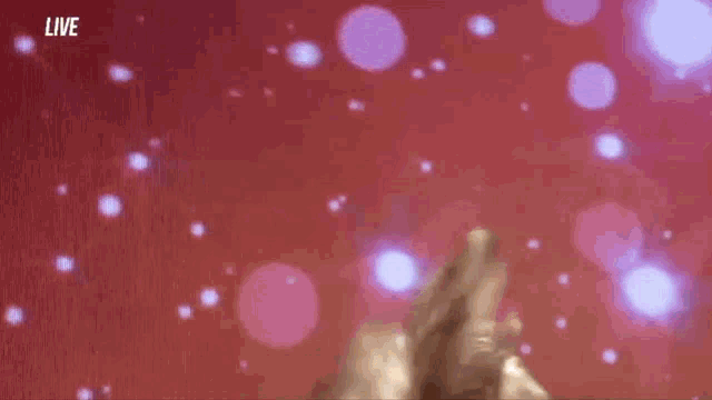 a woman is dancing on a stage in front of a live audience .