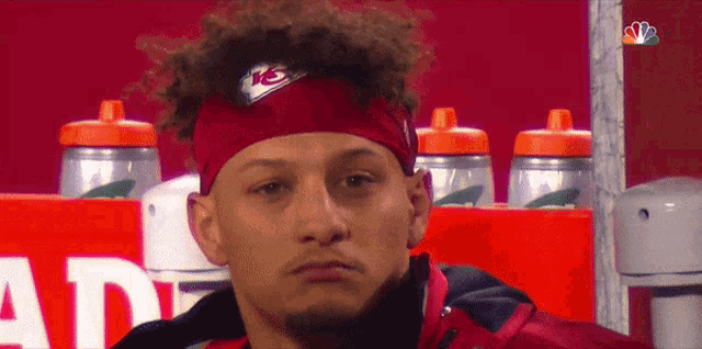 a man wearing a headband with a kc logo on it