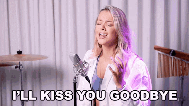 a woman singing into a microphone with the words " i 'll kiss you goodbye " written below her