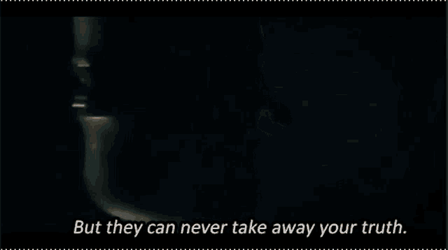 a close up of a person in a dark room with the words but they can never take away your truth .