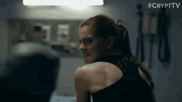 a woman in a black tank top is sitting in a hospital room with the hashtag #crypttv