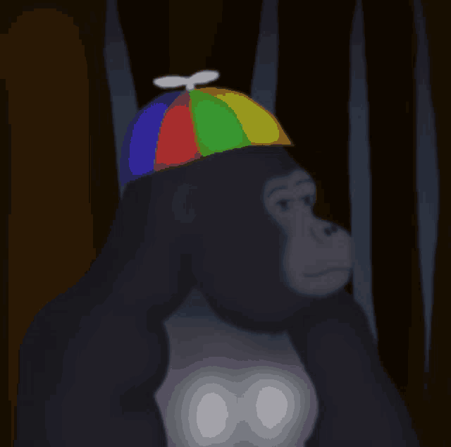 a gorilla is wearing a colorful hat with a propeller on top