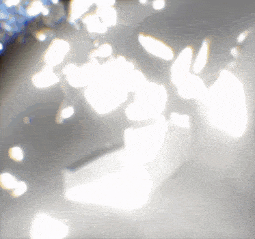 a blurry picture of a person 's face with a light shining on it