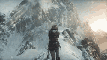 a person is walking up a snow covered mountain .
