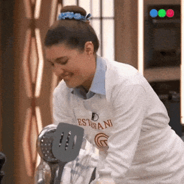 a woman wearing a sweater that says " estafani " on it