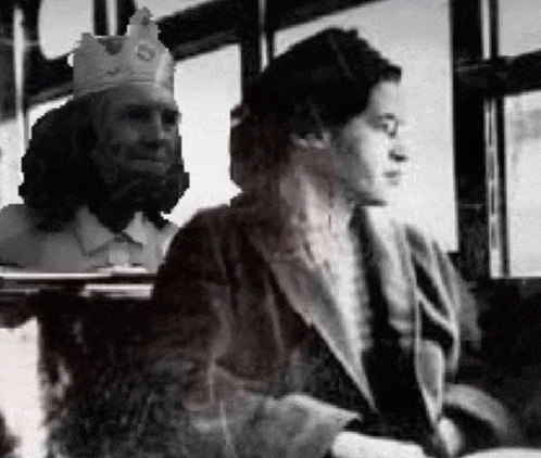 a black and white photo of a man wearing a crown sitting next to a woman on a bus .