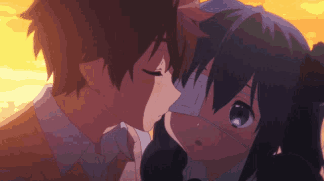 a boy and a girl are kissing and the girl has a mask on her face