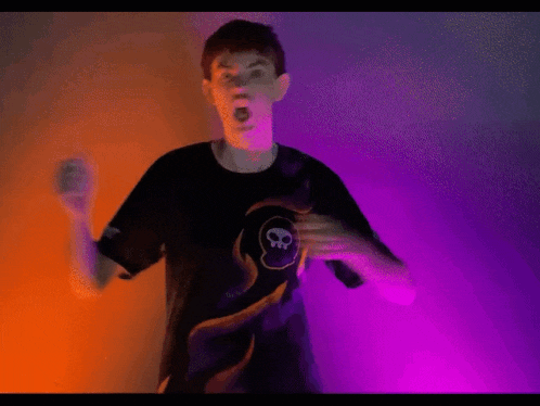 a boy wearing a shirt with a skull on it is screaming