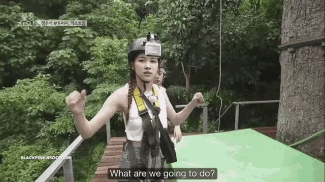 a woman wearing a helmet and a harness is asking what are we going to do