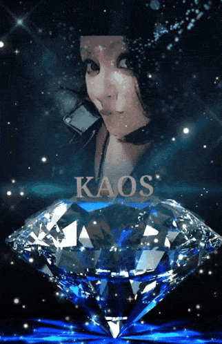 a woman is standing next to a large diamond with kaos written on it
