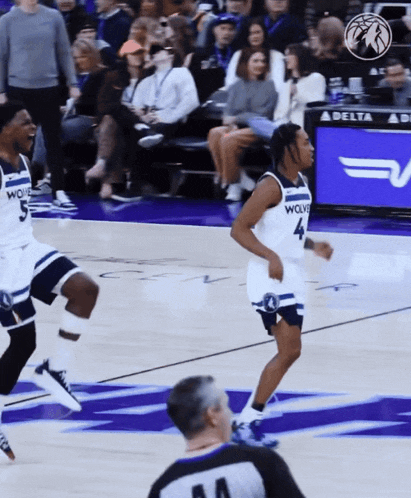 a basketball player with the number 4 on his jersey is running on the court