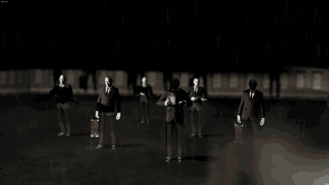 a group of men in suits are standing in a dark room