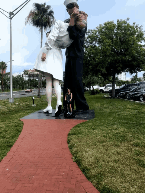 a statue of a man carrying a woman in a white dress