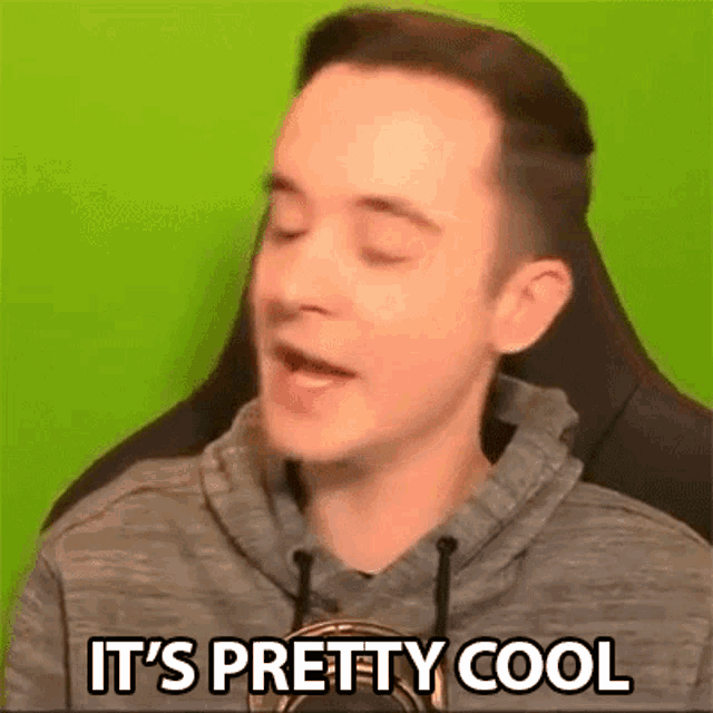 a man in a hoodie is sitting in a chair with his eyes closed and saying `` it 's pretty cool '' .
