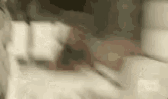a close up of a person laying on a bed with a knife .