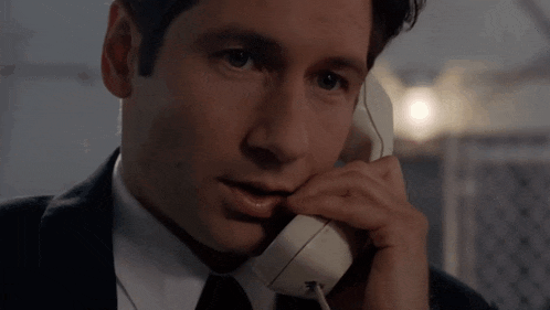 a close up of a man talking on a phone
