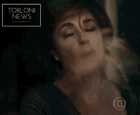 a woman with her eyes closed holds her hand to her forehead in front of a sign that says torloni news