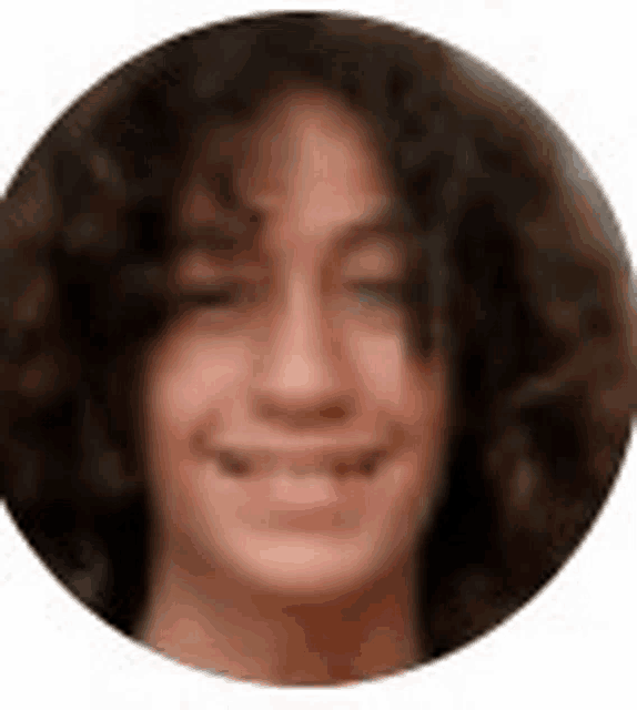 a young woman with curly hair is smiling in a circle .