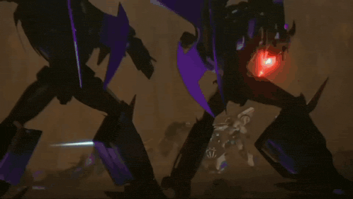 two transformers are fighting each other with sparks coming out of their mouths