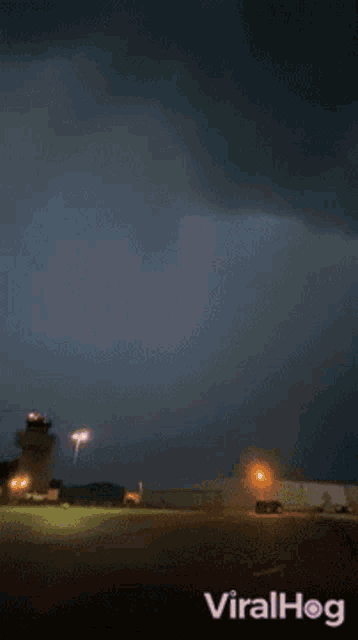 lightning strikes in a dark purple sky with viralhog written in the bottom right corner