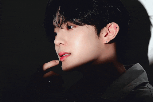 a close up of a person 's face with a black shirt
