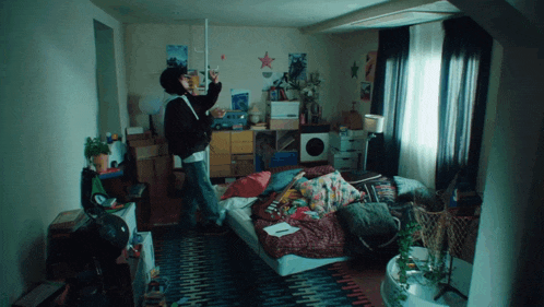 a person standing in a messy room with a star on the wall above them